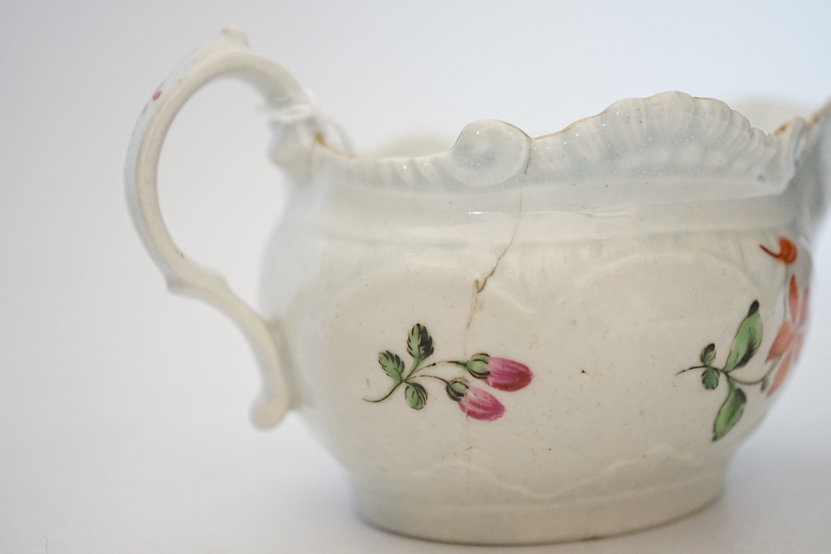 A Chaffers Liverpool saucer, c.1760 and two 18th century Christian or Pennington sauceboats, saucer 12cm diameter